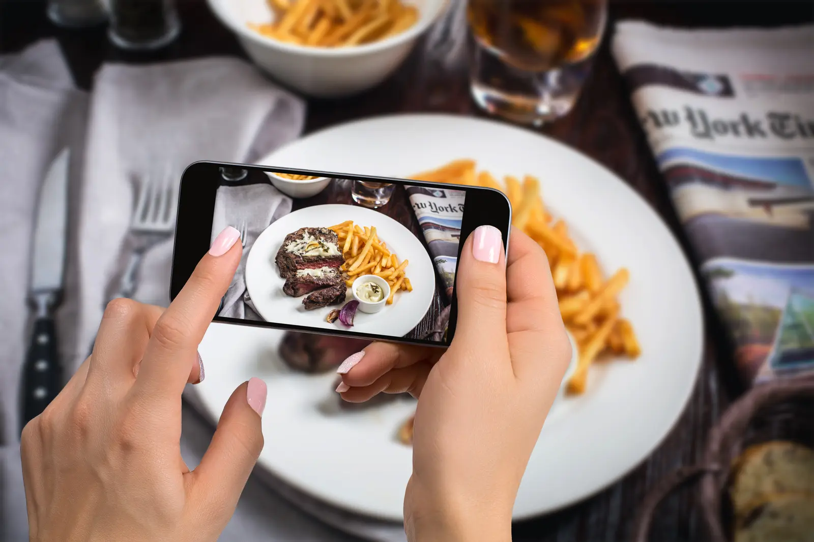 A guest photographing their plate at the table