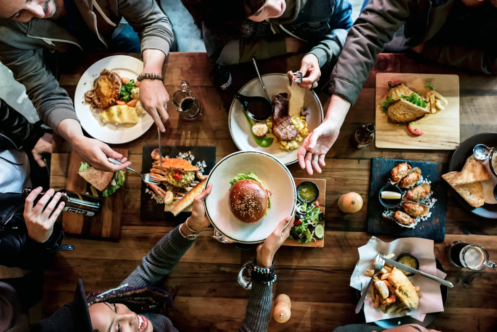 A full table of guests sharing dishes